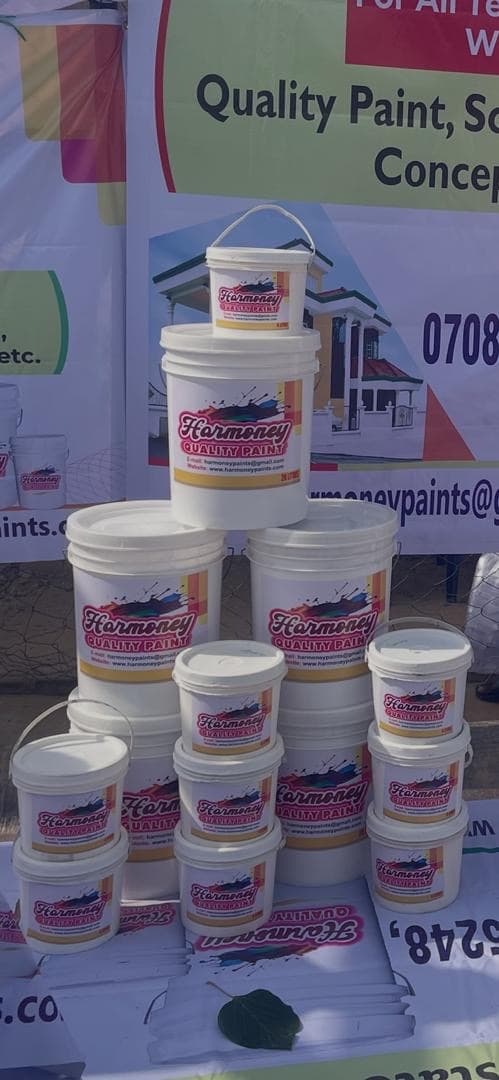 A stacked display of Harmoney Paints buckets.